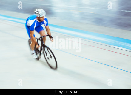 Track cyclist riding in velodrome Stock Photo
