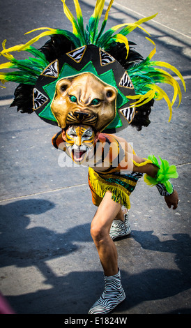 Barranquilla, Colombia - March 1, 2014 - Performers in elaborate costume sing, dance, and stroll their way down the streets of Barranquilla during the Battalla de Flores. The Pinnacle of the Carnival de Barranquilla parades. Stock Photo