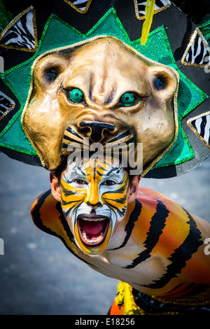 Barranquilla, Colombia - March 1, 2014 - Performers in elaborate costume sing, dance, and stroll their way down the streets of Barranquilla during the Battalla de Flores. The Pinnacle of the Carnival de Barranquilla parades. Stock Photo