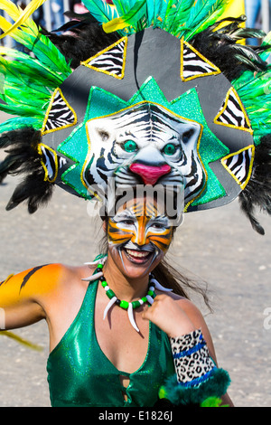 Barranquilla, Colombia - March 1, 2014 - Performers in elaborate costume sing, dance, and stroll their way down the streets of Barranquilla during the Battalla de Flores. The Pinnacle of the Carnival de Barranquilla parades. Stock Photo