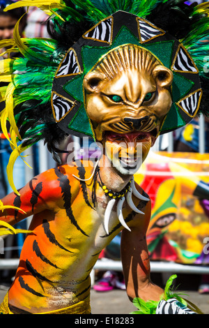 Barranquilla, Colombia - March 1, 2014 - Performers in elaborate costume sing, dance, and stroll their way down the streets of Barranquilla during the Battalla de Flores. The Pinnacle of the Carnival de Barranquilla parades. Stock Photo