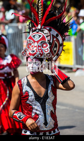 Barranquilla, Colombia - March 1, 2014 - Performers in elaborate costume sing, dance, and stroll their way down the streets of Barranquilla during the Battalla de Flores during Carnival Stock Photo