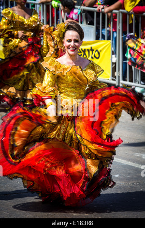 Barranquilla, Colombia - March 1, 2014 - Performers in elaborate costume sing, dance, and stroll their way down the streets of Barranquilla during the Battalla de Flores during Carnival Stock Photo