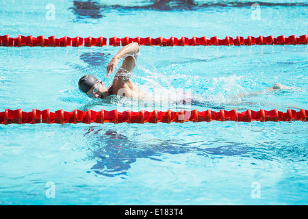 Swimmer racing in pool Stock Photo