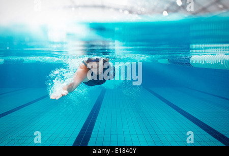 Swimmer racing in pool Stock Photo