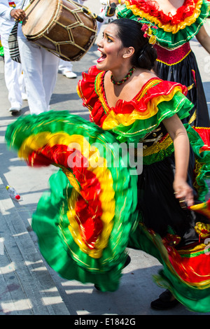 Barranquilla, Colombia - March 1, 2014 - Performers in elaborate costume sing, dance, and stroll their way down the streets of Barranquilla during the Battalla de Flores during Carnival Stock Photo