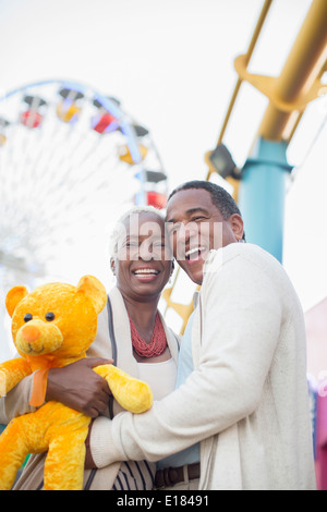 Portrait of smiling senior couple at amusement park Stock Photo