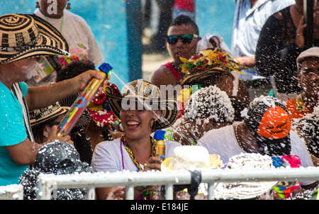 Barranquilla, Colombia - March 1, 2014 - Families and friends battle with white foam in the stands of the Barranquilla Carnival. The foam is basically soap and water sprayed from an arosol can. Stock Photo