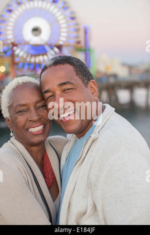 Portrait of happy senior couple at amusement park Stock Photo