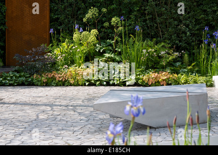 View of planting and granite asymmetric bench in the The RBC Waterscape Garden at RHS Chelsea Flower Show 2014 Stock Photo