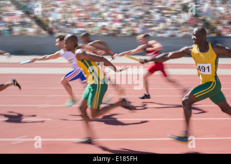 Blurred view of relay runners in race Stock Photo