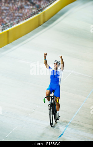 Track cyclist celebrating in velodrome Stock Photo