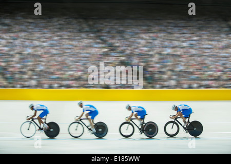 Track cycling team riding in velodrome Stock Photo