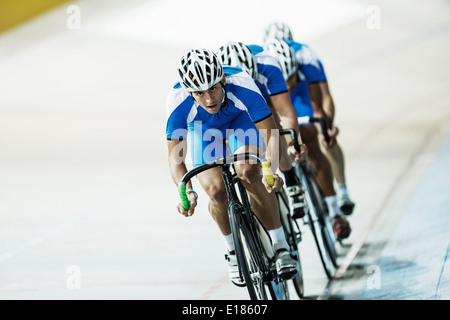 Track cycling team riding in velodrome Stock Photo