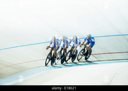 Track cyclists riding in velodrome Stock Photo