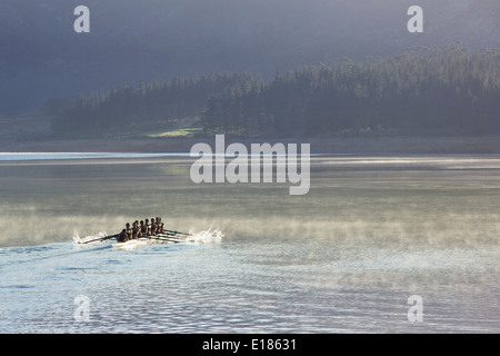 Rowing crew rowing scull on lake Stock Photo