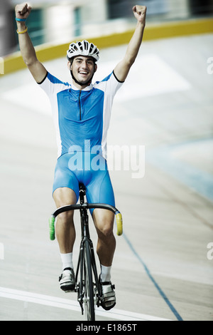 Track cyclist celebrating in velodrome Stock Photo