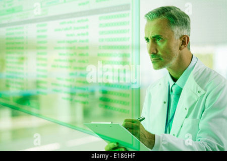 Serious doctor with clipboard Stock Photo