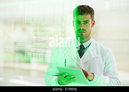 Serious doctor using digital tablet in hospital Stock Photo