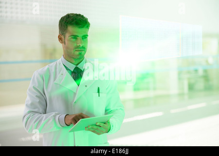 Serious doctor with digital tablet in hospital Stock Photo