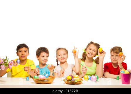 Five funny children with colourful Eastern eggs Stock Photo