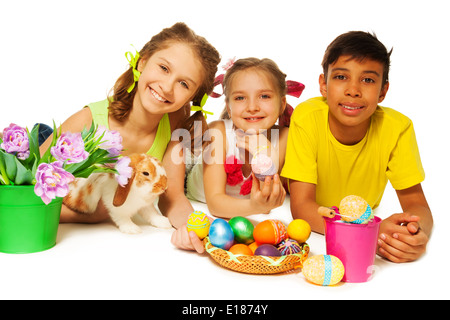 Three smiling kids together with Eastern eggs Stock Photo