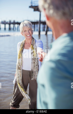 Senior couple holding hands on beach Stock Photo