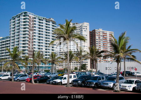 DURBAN, SOUTH AFRICA - MAY 24, 2004: Many parked vehicles and palm trees in front of residential complexes on Golden Mile Beach Stock Photo