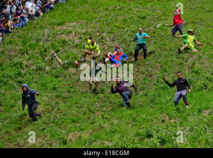 Gloucestershire, UK. 26th May, 2014.  Picture Shows:Cheese Rolling at Coopers Hill, Gloucestershire. This annual event sees competitors from as far away as New Zealand, Japan and Canada chase a 9lbs Double Gloucester Cheese down the steep hill, the cheese reaches up to 70 MPH Date ; 26/05/2014 Credit:  jules annan/Alamy Live News Stock Photo