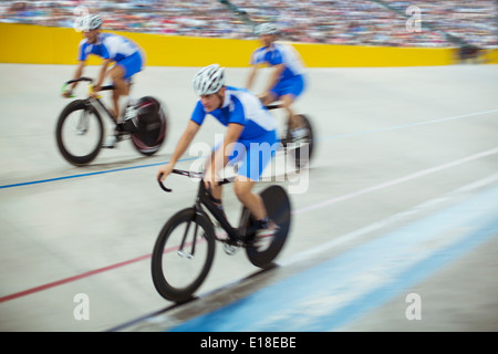 Track cycling team riding in velodrome Stock Photo