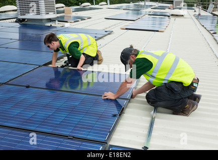 photovoltaic solar panels being installed on a roof Stock Photo
