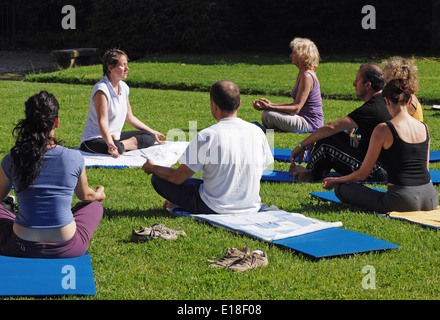 Yoga class in the park Stock Photo
