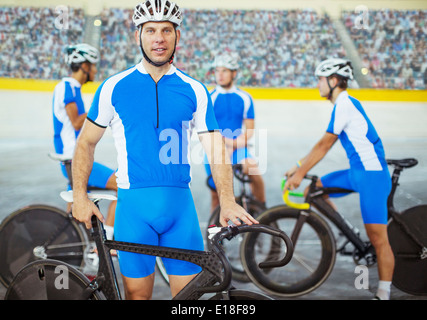 Track cyclists standing in velodrome Stock Photo