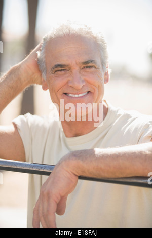 Portrait of smiling senior man outdoors Stock Photo