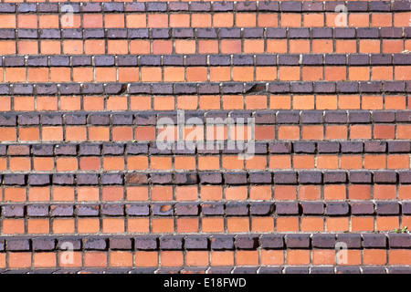 old chipped and weathered brick steps forming patterned texture Stock Photo