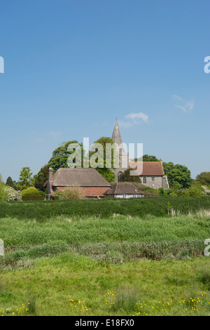 A view of St Andrews Church and the Clergy House in Alfriston, a picturesque village in the valley of the River Cuckmere in Suss Stock Photo