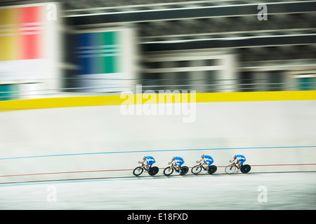 Track cycling team racing in velodrome Stock Photo