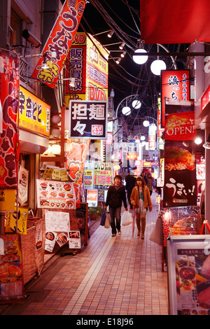 Narrow street filled with colorful restaurant signs at night in Nakano, Tokyo, Japan. Stock Photo