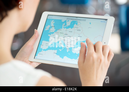 Woman looking on Google Maps application on a brand new white Apple iPad Air Stock Photo