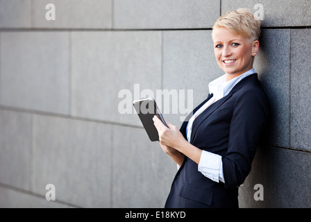 Attractive businesswoman using tablet Stock Photo