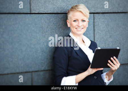 Attractive businesswoman using tablet Stock Photo