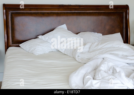 Double bed which is unmade and messy Stock Photo