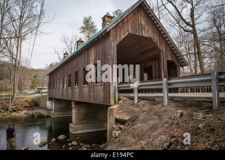 A man fishes on Little Pigeon River, by the Emerts Cove Covered Bridge in Pittman Center, Tennessee Stock Photo