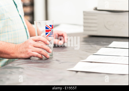 A customer waiting to be served on the opening day of THE HOOP BEER FESTIVAL in Stock Village in Essex in the UK. Stock Photo