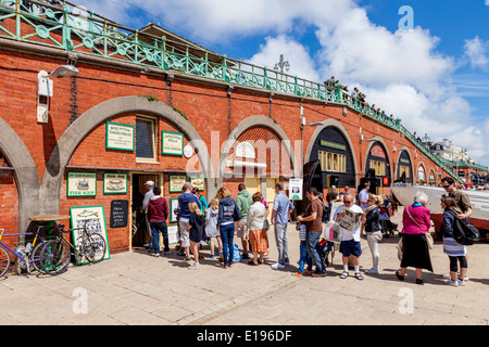 People Queueing To Buy Fish Meals At The Mackerel Fayre, Brighton Seafront, Sussex, England Stock Photo