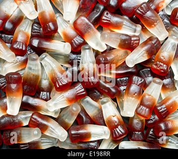 Chewy Cola Bottle background a popular retro sweet also known as Gummy candy at a pick and mix self service market. Stock Photo
