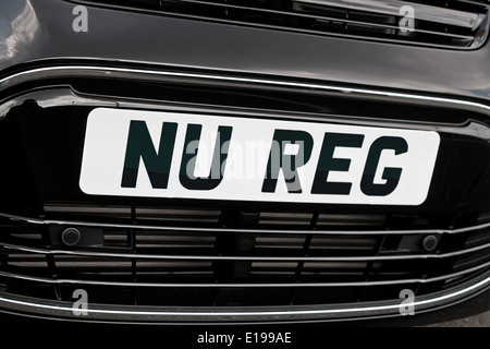 Registration plate on the front of a generic motorcar with 'Nu Reg' in black letters on white background for New car sales Stock Photo
