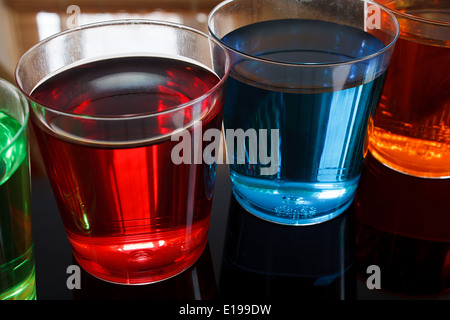 Close up of Multi colored Alcoholic shooters in shot glasses great example of a Drinks offer in a local bar. Stock Photo