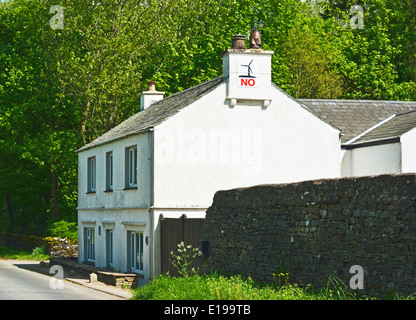 Windfarm protest poster on house chinmey stack. Orton, Cumbria, England, United Kingdom, Europe. Stock Photo