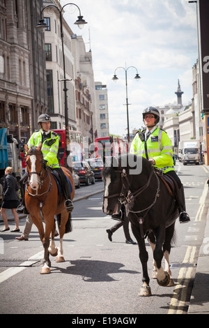 Metropolitan Mounted Police patrolling The Strand London. Stock Photo